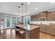 Spacious kitchen with a central island, pendant lighting, and a view of the dining area at 156 Greenhurst Cir, Holly Springs, NC 27540