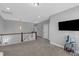Open loft area with a staircase, tv, and multiple bedrooms off of the main space at 156 Greenhurst Cir, Holly Springs, NC 27540