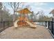 Community playground featuring slides, climbing structures, and a shaded seating area at 156 Greenhurst Cir, Holly Springs, NC 27540