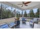 Relaxing screened porch with ceiling fan, comfortable seating, and a view of the backyard at 156 Greenhurst Cir, Holly Springs, NC 27540