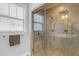 Contemporary bathroom shower features a glass door, bench, and dual shower heads at 156 Greenhurst Cir, Holly Springs, NC 27540