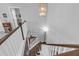 Overhead view of a wooden staircase with white banisters and a decorative light fixture at 156 Greenhurst Cir, Holly Springs, NC 27540