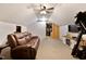 Attic featuring exposed beams, a ceiling fan and an electric fireplace at 166 Creek Dr, Louisburg, NC 27549