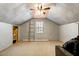 Attic featuring exposed beams, a ceiling fan, and a ladder at 166 Creek Dr, Louisburg, NC 27549