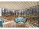 View of the back deck with a table and four chairs, perfect for outdoor dining and enjoying the surrounding scenery at 166 Creek Dr, Louisburg, NC 27549