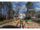 Picturesque backyard setting with mature trees, creating a tranquil outdoor space at 166 Creek Dr, Louisburg, NC 27549