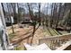 Backyard view showcasing a fire pit area with Adirondack chairs and a wooded backdrop at 166 Creek Dr, Louisburg, NC 27549