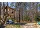 Backyard featuring a treehouse, golf cart, kayaks, and outdoor activities at 166 Creek Dr, Louisburg, NC 27549