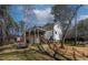 Scenic backyard featuring a covered deck, ideal for relaxation and outdoor entertainment at 166 Creek Dr, Louisburg, NC 27549