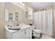 Bathroom featuring a single sink vanity with a neutral color palette and decorative accents at 166 Creek Dr, Louisburg, NC 27549