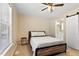 A bedroom with a metal bed frame, a ceiling fan and a small bathroom at 166 Creek Dr, Louisburg, NC 27549