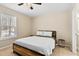 A bedroom with a wooden bed frame, a ceiling fan and small side table at 166 Creek Dr, Louisburg, NC 27549