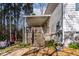 Wooden deck featuring a covered porch with stairs leading to a yard and grill at 166 Creek Dr, Louisburg, NC 27549