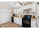 Charming kitchen features white cabinets, butcher block countertops, and black appliances at 166 Creek Dr, Louisburg, NC 27549