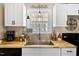 This home has a stainless steel sink, butcher block countertop, and white cabinets at 166 Creek Dr, Louisburg, NC 27549
