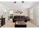 Comfortable living room with brown leather sofa, wooden coffee table, and neutral decor at 166 Creek Dr, Louisburg, NC 27549