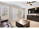 Bright living room with a ceiling fan, large windows, and a comfortable seating area at 166 Creek Dr, Louisburg, NC 27549
