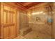 Close up of glass enclosed shower with built in bench and tile at 171 Robert Whitfield Rd, Hurdle Mills, NC 27541