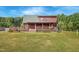 Charming log cabin home featuring a spacious deck and covered porch at 171 Robert Whitfield Rd, Hurdle Mills, NC 27541