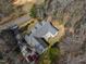 Aerial view showcases the home with adjacent street, trees, and cars at 180 Normandy Rd, Louisburg, NC 27549