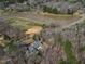 Aerial view showcasing a lake, surrounded by trees and homes in the community at 180 Normandy Rd, Louisburg, NC 27549