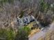 Aerial view showing home nestled in wooded area with long driveway at 180 Normandy Rd, Louisburg, NC 27549