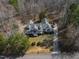 Aerial view of the property showing the house, driveway, and surrounding trees at 180 Normandy Rd, Louisburg, NC 27549