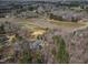 Community aerial view showing lake, surrounding homes, and mature trees at 180 Normandy Rd, Louisburg, NC 27549