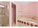 Bathroom featuring a shower and tub with decorative tile accents at 180 Normandy Rd, Louisburg, NC 27549