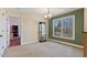 Dining room with neutral carpet, large window, and display case with decorative items at 180 Normandy Rd, Louisburg, NC 27549