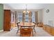 Traditional dining room with a wooden table, cabinet, and multiple windows providing ample natural light at 180 Normandy Rd, Louisburg, NC 27549