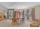 This dining room includes a wood table with multiple windows and a wooden cabinet for storage at 180 Normandy Rd, Louisburg, NC 27549