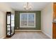 This dining room features a large window with green walls and a wooden display case at 180 Normandy Rd, Louisburg, NC 27549