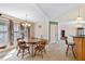 Dining room with round wood table, three windows, and open doorway at 180 Normandy Rd, Louisburg, NC 27549
