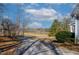 The driveway of this home looks out toward a lake at 180 Normandy Rd, Louisburg, NC 27549