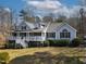 Inviting single-story home boasting a spacious front porch, manicured lawn, and classic architectural details at 180 Normandy Rd, Louisburg, NC 27549