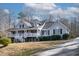 Charming gray home with a welcoming front porch and well-maintained landscaping at 180 Normandy Rd, Louisburg, NC 27549
