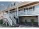 Inviting covered front porch featuring white railings and columns, leading to a quaint entrance with wood ceiling at 180 Normandy Rd, Louisburg, NC 27549