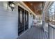 Welcoming front porch with double front doors, beautiful lighting, and a cozy rocking chair at 180 Normandy Rd, Louisburg, NC 27549