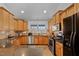Well-equipped kitchen with oak cabinets, granite countertops, and modern stainless steel appliances at 180 Normandy Rd, Louisburg, NC 27549