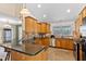 Bright kitchen with granite countertops, stainless steel appliances, and tiled flooring at 180 Normandy Rd, Louisburg, NC 27549