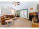 Comfortable living room with vaulted ceiling, fireplace, and dual French door entrance at 180 Normandy Rd, Louisburg, NC 27549