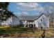 Back of a house with a lawn and deck. Some outdoor storage is visible at 180 Normandy Rd, Louisburg, NC 27549
