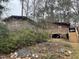View of the home's wooden deck with stairs to the backyard surrounded by trees at 182 Tree Cutters, Sanford, NC 27332