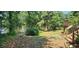 The backyard has lake views, trees, grass, a deck, and stairs leading down to the water at 182 Tree Cutters, Sanford, NC 27332