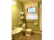 Bathroom with grab bars, window, and neutral tile flooring at 182 Tree Cutters, Sanford, NC 27332