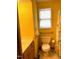 Bright yellow bathroom features a new toilet and grab bars at 182 Tree Cutters, Sanford, NC 27332