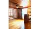 Cozy bedroom featuring wood paneling, hardwood floors, and a ceiling fan with light fixture at 182 Tree Cutters, Sanford, NC 27332