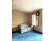 Bedroom features blue carpeting, neutral walls, a plaid loveseat and a window with curtains at 182 Tree Cutters, Sanford, NC 27332