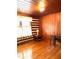 A bedroom with hardwood floors and log walls provides a rustic charm at 182 Tree Cutters, Sanford, NC 27332